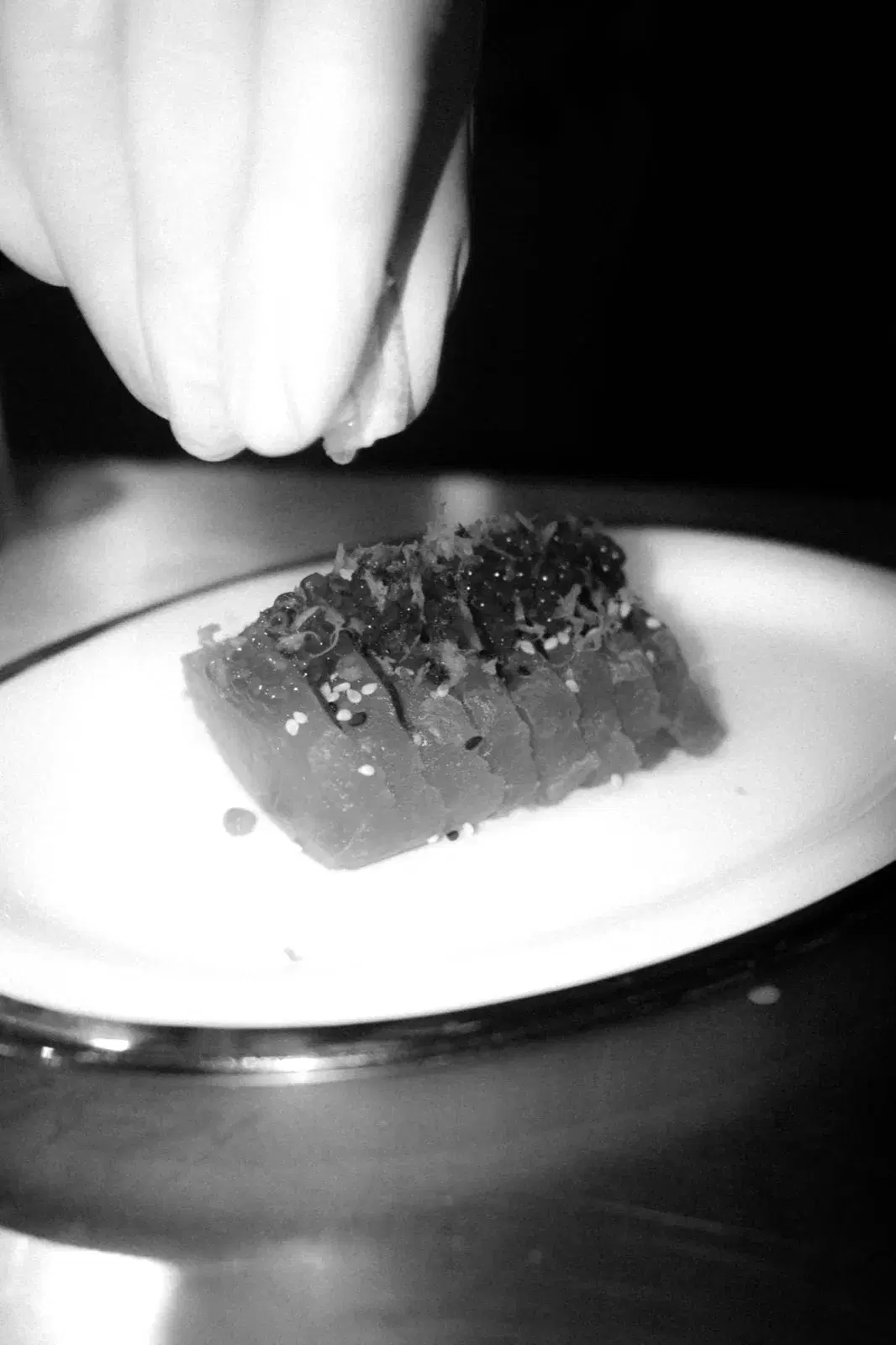 Chef finishing a tuna dish